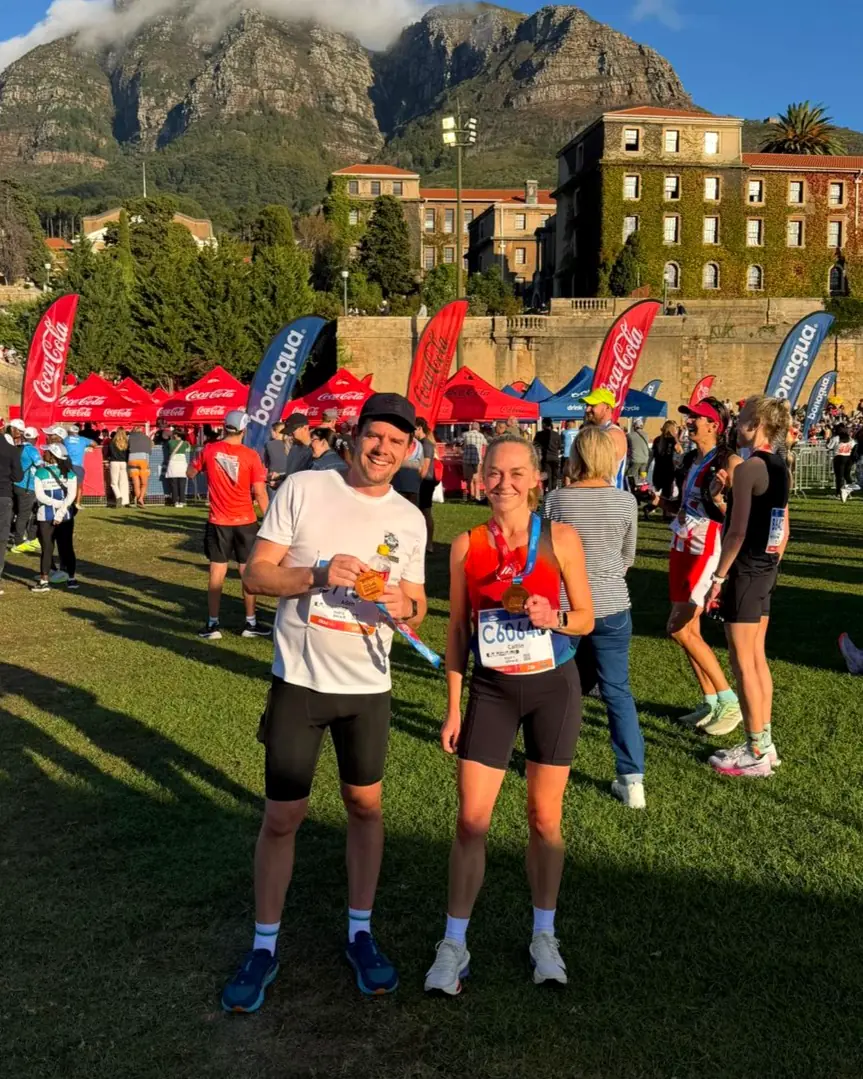 Two Velocity runners with their medals at the Two Oceans finish
